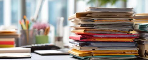 The cluttered office desk filled with various stacks of paperwork and folders. photo