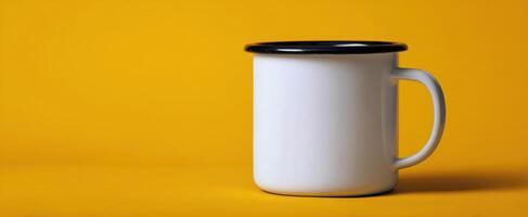The enamel mug showcasing contrasting colors against a vibrant yellow background. photo
