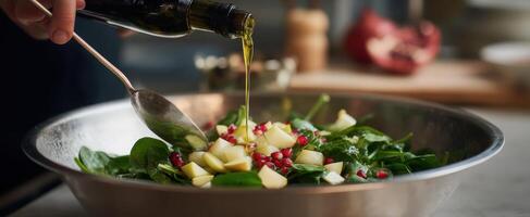 The vibrant salad being drizzled with olive oil in a modern kitchen. photo