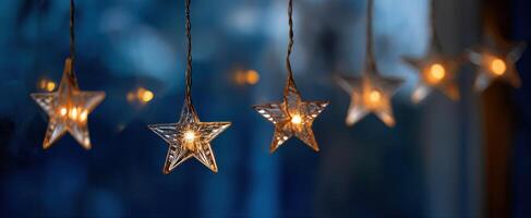 The beautiful illuminated glass star decorations glowing softly at twilight. photo