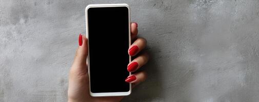 The stylish hand holding a smartphone against a textured background. photo