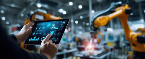 The tablet displaying data analysis in a modern automated manufacturing environment. photo