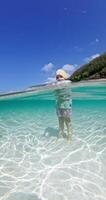 Little child girl standing in tropical sea on sunny day, split shot in ocean video
