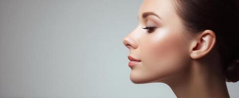The elegant profile of a beautiful woman highlighting flawless skin and makeup. photo