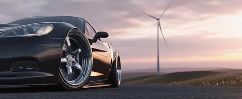 The sleek black sports car against a picturesque landscape with a wind turbine. photo