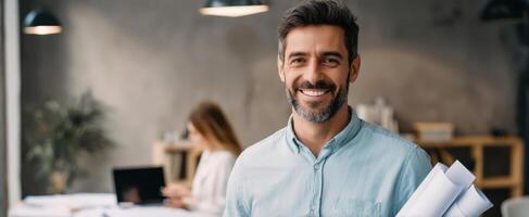 The smiling man with blueprints in a modern office setting. photo