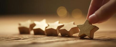 The hand selecting a wooden star from a line of decorative stars photo
