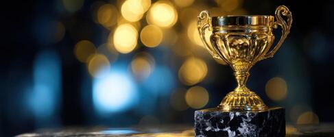 The Elegant Gold Trophy on a Dark Marble Base with Glowing Background photo