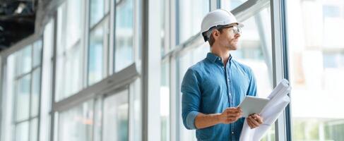 The construction professional assessing project plans in a modern office environment. photo