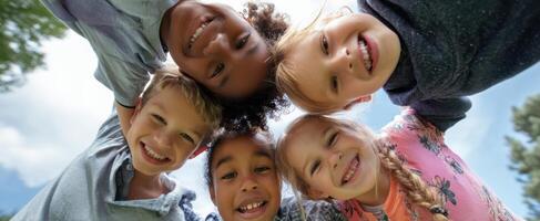 The joyful children smiling together in a circle on a sunny day. photo
