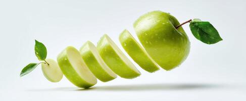 The Green Apple Sliced and Floating in Mid-Air with Fresh Water Drops photo