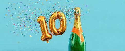 The sparkling champagne bottle celebrating a milestone with golden balloons and confetti. photo