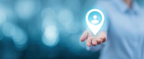The hand presenting a digital location pin symbolizing connectivity and user engagement. photo