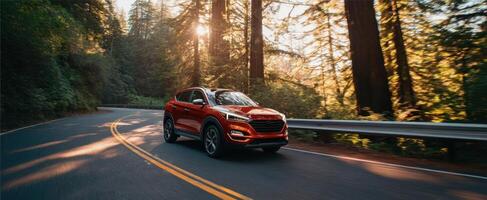 The striking red SUV navigating through a scenic forest road at sunset. photo