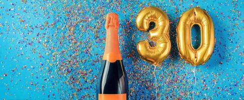 The champagne bottle and golden balloons celebrating a milestone birthday. photo