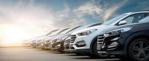 The lineup of modern SUVs under a stunning sunset sky. photo