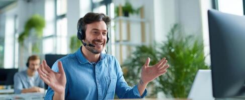 The smiling man in a headset engages in a call at work. photo