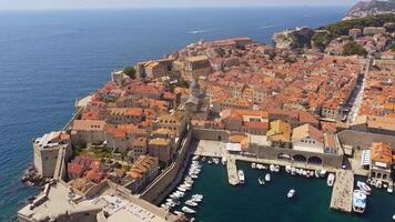 Aerial view of the Cathedral of the Assumption of Mary near the port in Dubrovnik. View from above of the church in the center with the roofs of the houses of the historic city of Dubrovnik, Croatia video