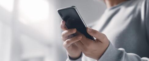 The smartphone held in hands displaying the modern digital lifestyle. photo