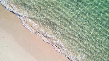 close up zenithal shot of the water of the waves on the shore of a beach on a calm sea day video