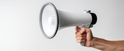 The megaphone held in a hand for impactful communication and announcements. photo