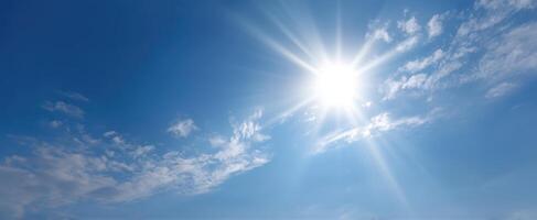 The sun shines brightly in the blue sky photo
