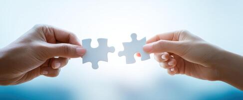 The Hands Connecting Puzzle Pieces Symbolizing Collaboration and Unity photo