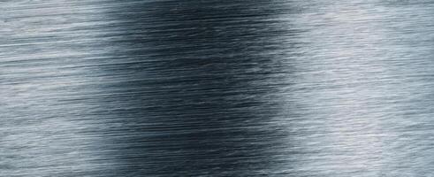 The sleek brushed metal surface showcasing intricate texture and reflections. photo