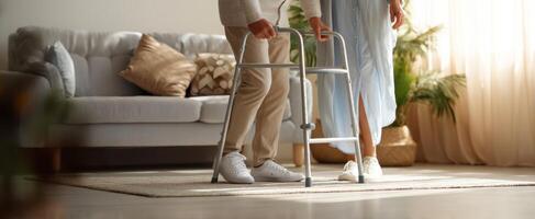 The elderly man receiving help with a walker in a cozy living room setting. photo