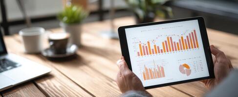 The tablet displaying data analytics and business performance metrics in an office setting. photo