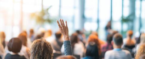 The engaged audience with raised hands during a lively conference session. photo