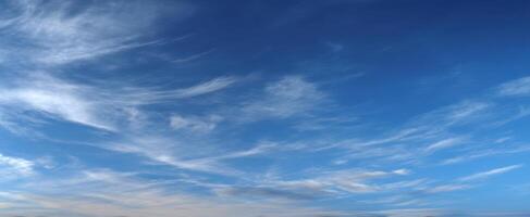 The Ethereal Beauty of a Clear Blue Sky with Wispy Clouds photo