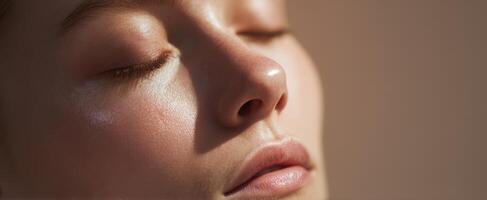 A woman with her eyes closed and her nose closed photo