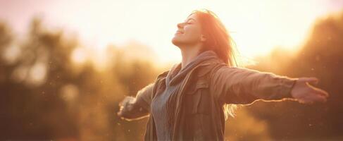 The woman embracing freedom and joy in a serene natural setting. photo