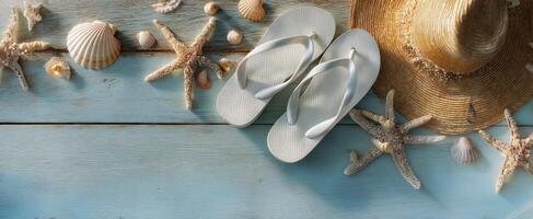 The beach scene with flip-flops and seashells on a wooden table. photo