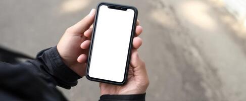 The Smartphone Held in Hand With Blank Screen in Urban Environment photo