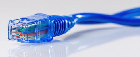 The Ethernet Cable Connector with Blue Wire on a Reflective Surface photo