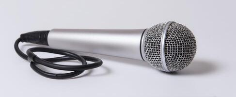 The microphone laying on a white background for audio and music performance. photo