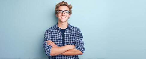 The cheerful teenager standing confidently against a blue background. photo