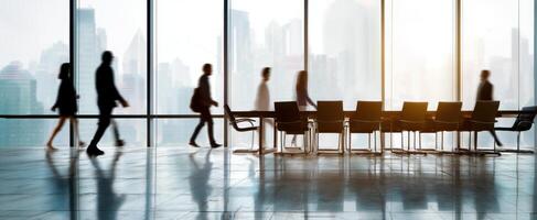 The silhouettes of business professionals walking in a modern office space. photo