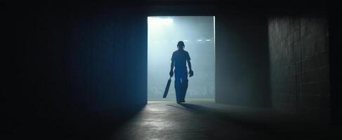 The cricket player emerges from the tunnel into the spotlight of the stadium. photo