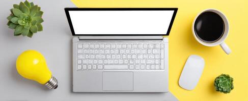 The laptop and coffee cup on a vibrant and creative workspace. photo