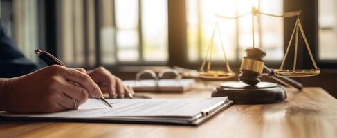 Lawyer writing on paper with pen and scales of justice photo