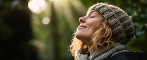 The woman enjoying tranquility in nature with a peaceful smile. photo