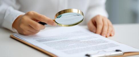 The magnifying glass focusing on important details in a document. photo