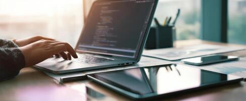 The laptop with a programmer's hands typing in a modern workspace. photo
