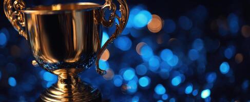 The shining trophy against a stunning blue bokeh background. photo