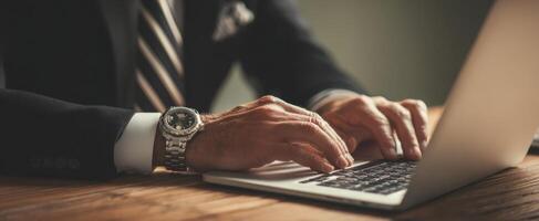 The professional's hands typing on a laptop in an elegant workspace. photo