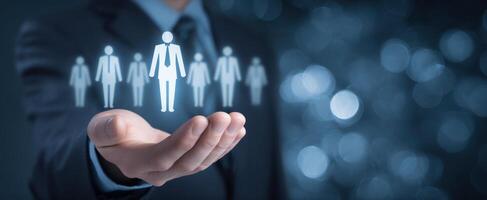 The businessman presenting a digital network of people icons in his hand. photo