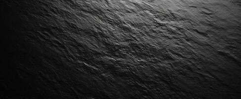 The sleek dark slate surface with beautiful texture and shadows. photo